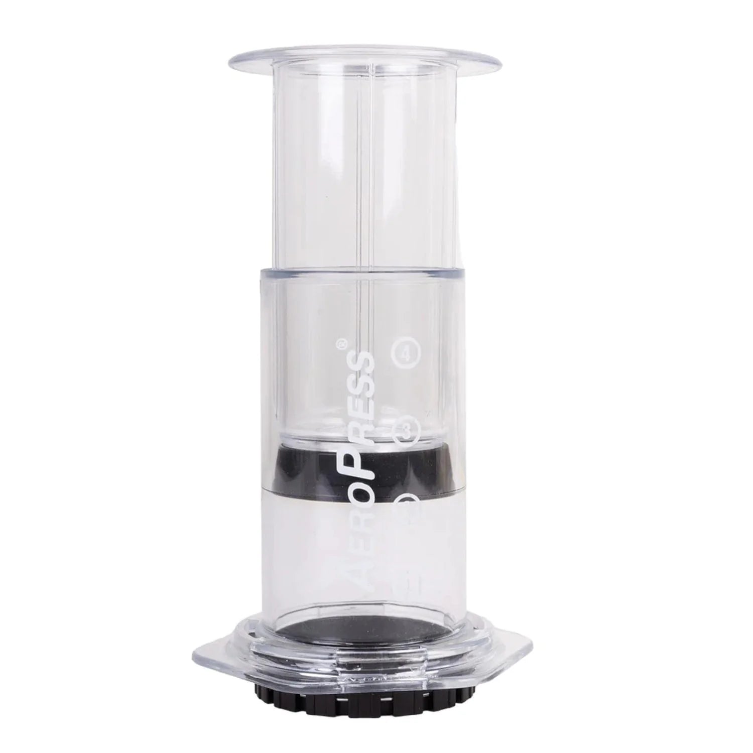 A red AeroPress coffee maker with a transparent chamber and a white filter filled with coffee grounds.