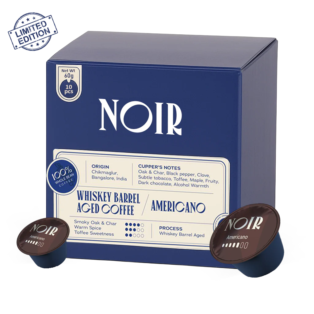 NOIR coffee packaging with two coffee pods on a white background