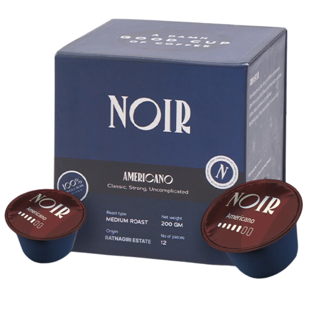 NOIR Americano coffee capsules with packaging on a white background